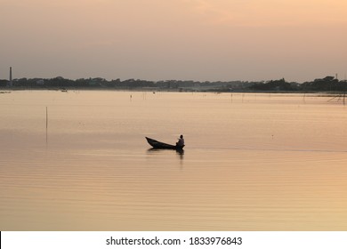 Small boat with man in the river