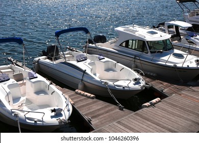 A Small Boat Moored In A Calm Marina