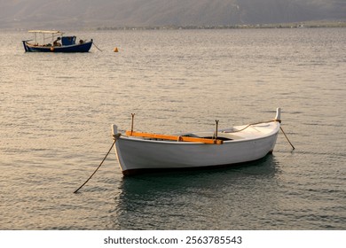 A small boat moored in a safe harbor, natural light. - Powered by Shutterstock