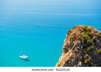 Small boat on the crystal clear mediterranean sea, Calabria, Italy