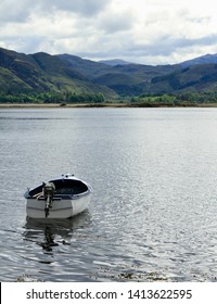 Small Boat On Its Way To Mountains In Highlands Of Scotland (Loch Carron) 