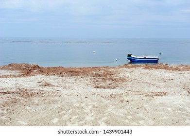 Small boat outsde the beach of Dürres, Albania. No people, sandy beach and blue ocean.