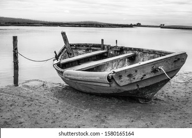 Small boat tied up waiting for the tide 