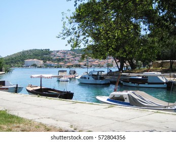 Small boats at local marina water front in historical european small town Sunny summer day scene with blue clear sky and sea background Recreation, relax, travel, vacation concept with empty copyspace