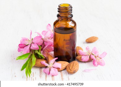 small bottle of almond oil, nuts and flowers