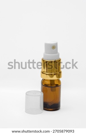 A small bottle with an atomizer for spraying perfume, eau de toilette in a small, handy spray bottle