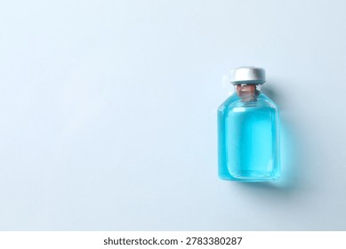 Small bottle with a blue liquid. Examples of vaccines and other medical equipment