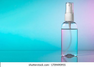 Small bottle instant hand sanitizer mist spray  Antibacterial alcohol antiseptic liquid in transparent plastic container and atomizer pump gradient background  no label  Copy space for text 