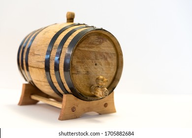 A Small Bourbon Barrel On A White Background. Corn Whiskey Is Aged For Varying Lengths Of Time In An Oak Barrel To Make Bourbon. Bourbon Is Usually Associated With The Southern US, Primarily Kentucky.