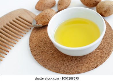 Small Bowl With Almond Oil And Wooden Hair Comb For Natural Hair Care. Homemade Cosmetics.