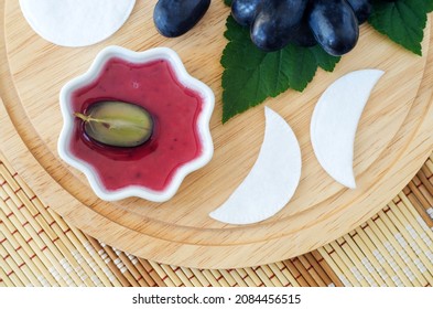 Small Bowl With Red Grape Juice (vinegar, Extract, Tincture) And Cotton Eye Patches. Ingredients For Preparing Diy Eye Or Face Mask. Natural Beauty Treatment And Spa Recipe. Top View, Copy Space. 