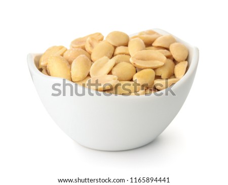 Small bowl of roasted salted peanuts isolated on white