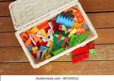 Small box filled with children's small toys for education. View from top. 