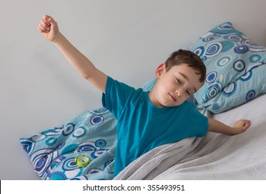 The Small Boy  With Alarm Clock In  The Bed , Wake Up


