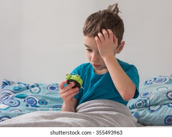 The Small Boy  With Alarm Clock In  The Bed , Wake Up


