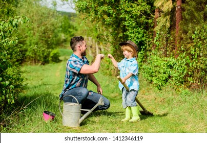 Small Boy Child Help Father In Farming. Eco Farm. Father And Son In Cowboy Hat On Ranch. Use Watering Can And Pot. Garden Equipment. Happy Earth Day. Family Tree Nursering. Childrens Day.