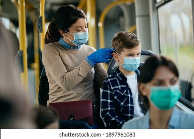 Small boy commuting by public transport with his mother who is adjusting his protective face mask.  - Powered by Shutterstock