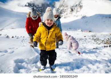 Small Boy With Family In Winter Nature, Walking In The Snow.