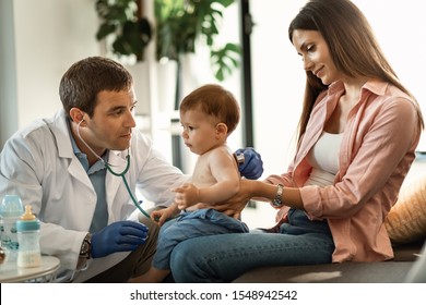 Small Boy Having A Medical Examination By Pediatrician While Being With His Mother At Clinic. 