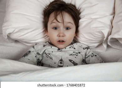 Small Boy Lies In Bed With His Eyes Open, Afraid Of Nightmares And Terrible Dreams In Children