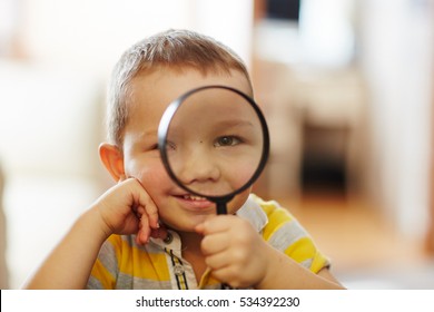 small boy with magnifier glass