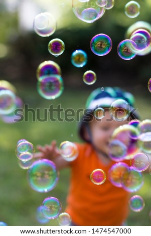 Similar – Image, Stock Photo Nu blow times fast ! (Boy portrait with soap bubbles, detail)