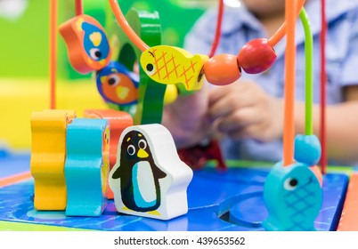 Small Boy Playing With Color Animal Maze Puzzle Toy For Child Development In Play Area. For Children Education Play And Learn Growth Concept.