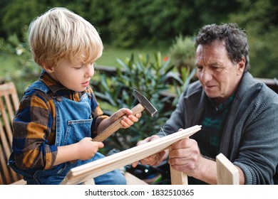 Small Boy With Senior Grandfather Constructing Birdhouse, Diy Project.