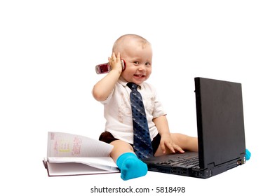 The small boy sits with the computer on a white background