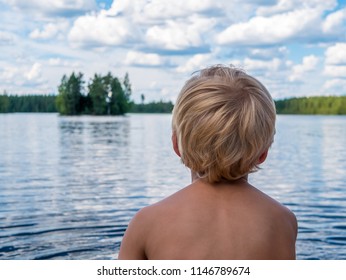 Small Boy Sits And View The Lake.