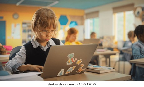 Small Boy Using Laptop Computers while Studying STEM and Information Technology Disciplines in Grade School. Teacher Educating Smart Boys and Girls - Powered by Shutterstock