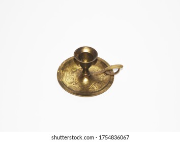 A Small Brass Candle Holder On A White Background 