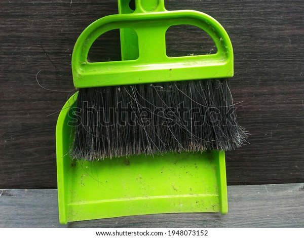a small broom for the inside of a car or other\
small room.
