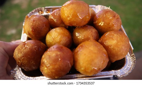 Small brown doughy balls coated with sugar syrup. This doughnut balls is famous sweets or dessert in United Arab Emirates particularly in Dubai. - Shutterstock ID 1734353537