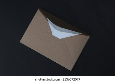 A Small Brown Envelope Isolated On A Black Background. Love Letter