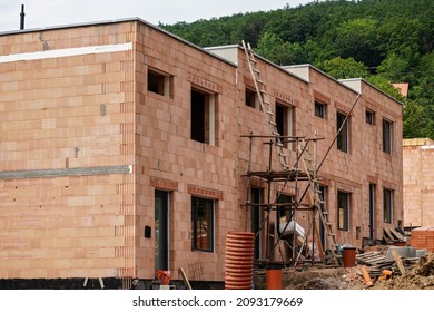 Small Building Construction Site, Wall Made Of Orange Bricks, Small Scaffolding Near