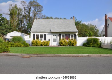Small Bungalow Cottage Style Suburban Home on Sunny Day in Residential Neighborhood