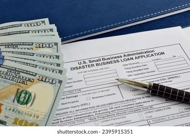 Small business Administration Disaster Business loan application form on the office table with pen and dollar bills - Shutterstock ID 2395915351