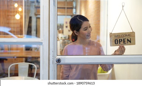 Small Business, An Asian Woman Who Owns A Business Opens The Store And Smiles To Welcome Customers.