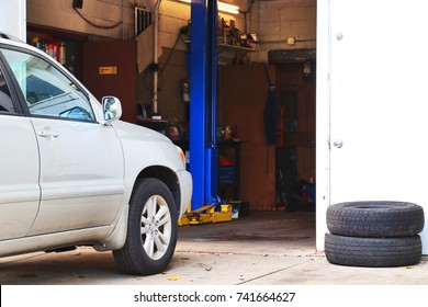 Small Business Background. Car Waiting For Check Up In Front Of Small Auto Service Shop. Car Repair And Service Background.