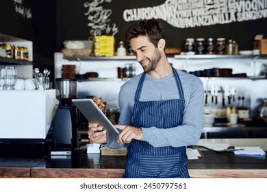 Small business, coffee shop and man with tablet checking online review, web or reservation in cafe. Networking, smile and restaurant manager, waiter or owner with digital app for service stock report - Powered by Shutterstock