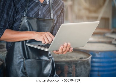 Small Business Concept.  Owner Factory Using Laptop Computer.