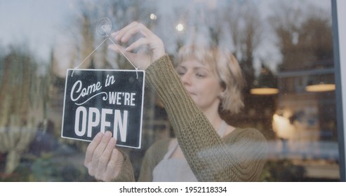 Small Business Entrepreneur Female Opening Store, Turning Open Sign And Look Outside For Customer