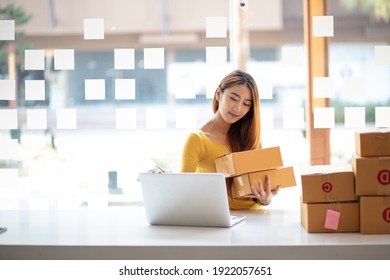 Small business entrepreneur SME freelance,Portrait of young asian  woman working at home office,online marketing packaging delivery box,e-commerce business concept. - Shutterstock ID 1922057651