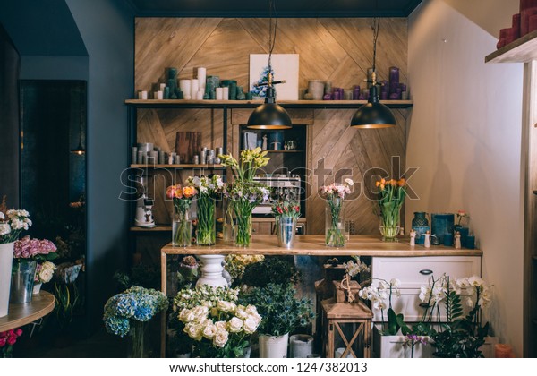 Small\
business. Flower shop interior. Floral design studio, decorations\
and arrangements and gifts. Flowers delivery service and sale of\
home plants in pots, wooden showcase,\
nobody.