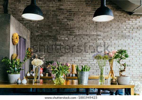 Small business.\
Flower shop loft modern interior. Floral design studio, decorations\
and compositions, gifts. Flower delivery and sale of indoor plants\
in pots, showcase,\
nobody.