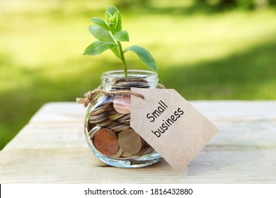 Small Business. Glass Jar With Coins, On A Wooden Table, On A Natural Background. 