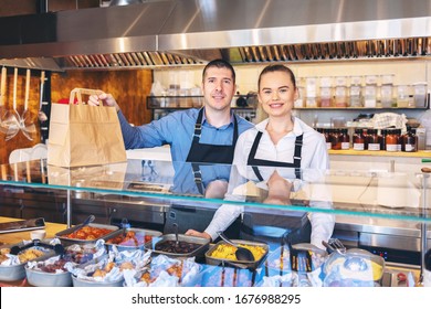 Small Business And To Go Service Concept Due To Isolation Emergency With Young Restaurant Owners Working Hard For Take Away Food Orders And Deliveries To Clients Staying At Home In Quarantine