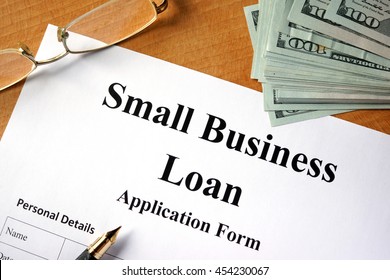 Small Business Loan Form On A Wooden Table.
