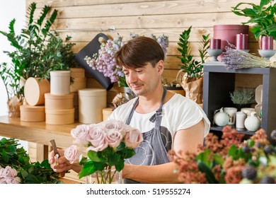 Small Business. Male Florist Making Rose Bouquet In Flower Shop. Man Assistant Or Owner In Floral Design Studio, Making Decorations And Arrangements. Flowers Delivery, Creating Order